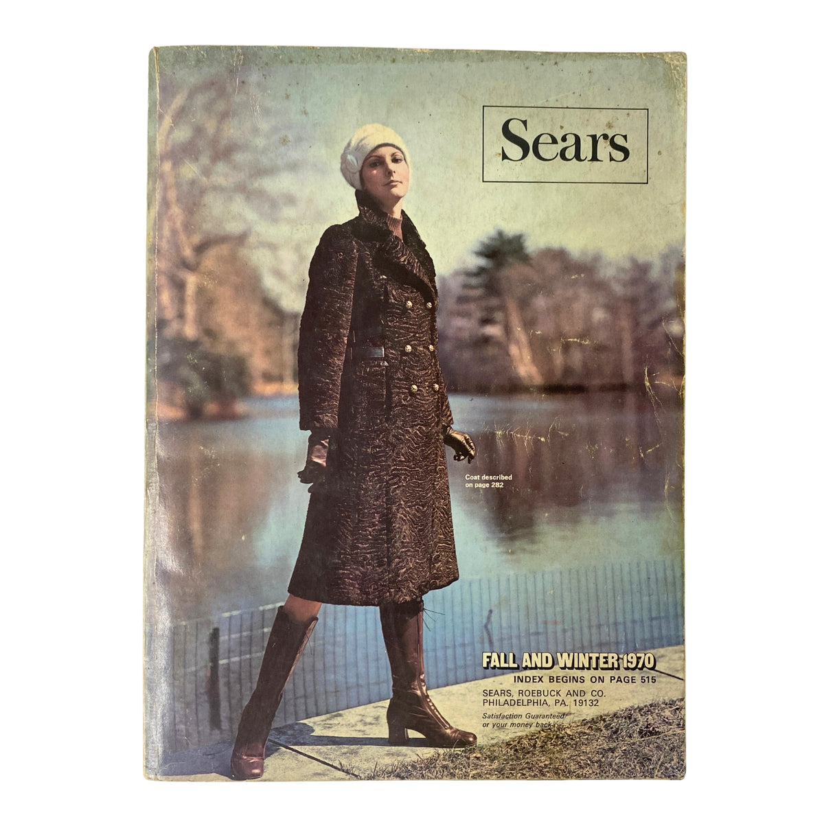 Cover of the 1970 Sears Fall and Winter Catalog featuring a fashion model in a stylish coat and hat, set against a serene outdoor backdrop, showcasing vintage fashion.