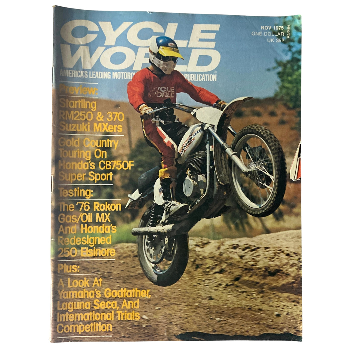 Cycle World Magazine November 1975 featuring Suzuki’s RM250 and 370 MXERS, with an image of a motocross rider performing a stunt on a motorcycle.