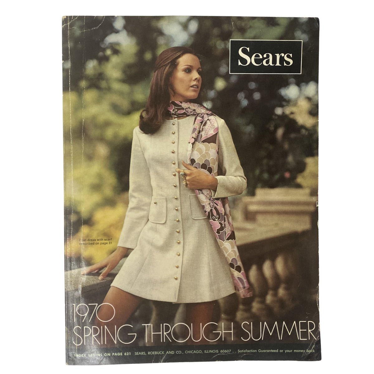 Cover of the 1970 Sears Junior Bazaar Spring and Summer Catalog featuring a model wearing a stylish cream-colored dress with buttons and a patterned scarf, capturing the essence of early '70s youth fashion.