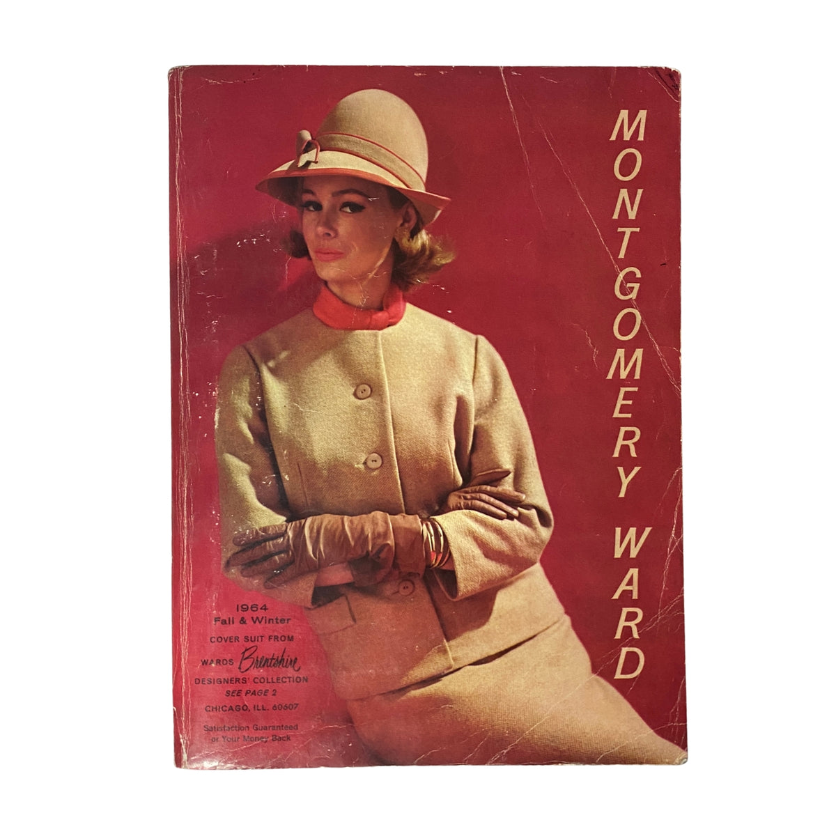 Cover of the 1964 Montgomery Ward Fall and Winter Catalog featuring a model in vintage fashion, showcasing a stylish winter coat and hat against a vibrant red background.