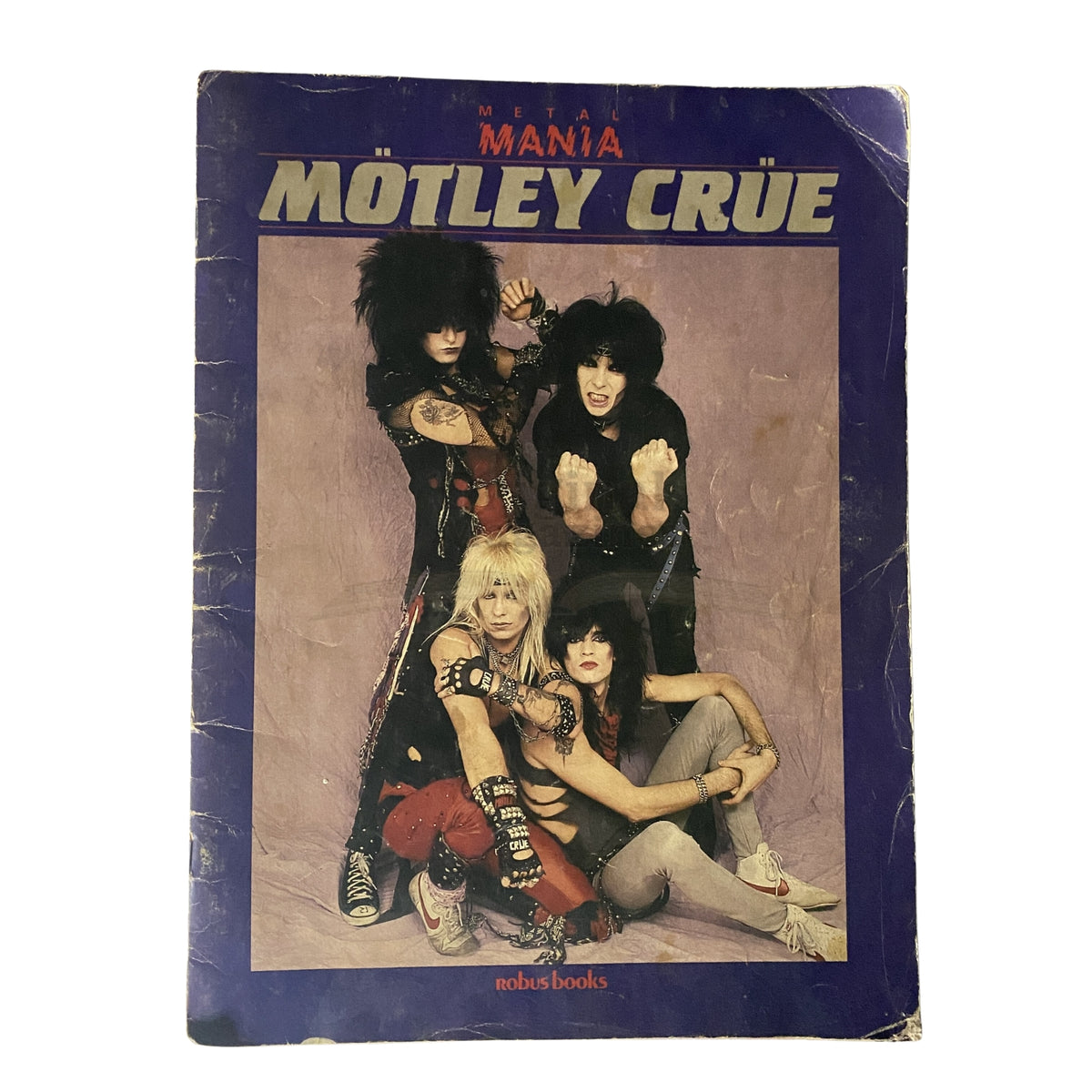 1984 Mötley Crüe Metal Mania magazine cover featuring the iconic rock band in vibrant costumes, showcasing their flamboyant style and energy, perfect for heavy metal enthusiasts and collectors.