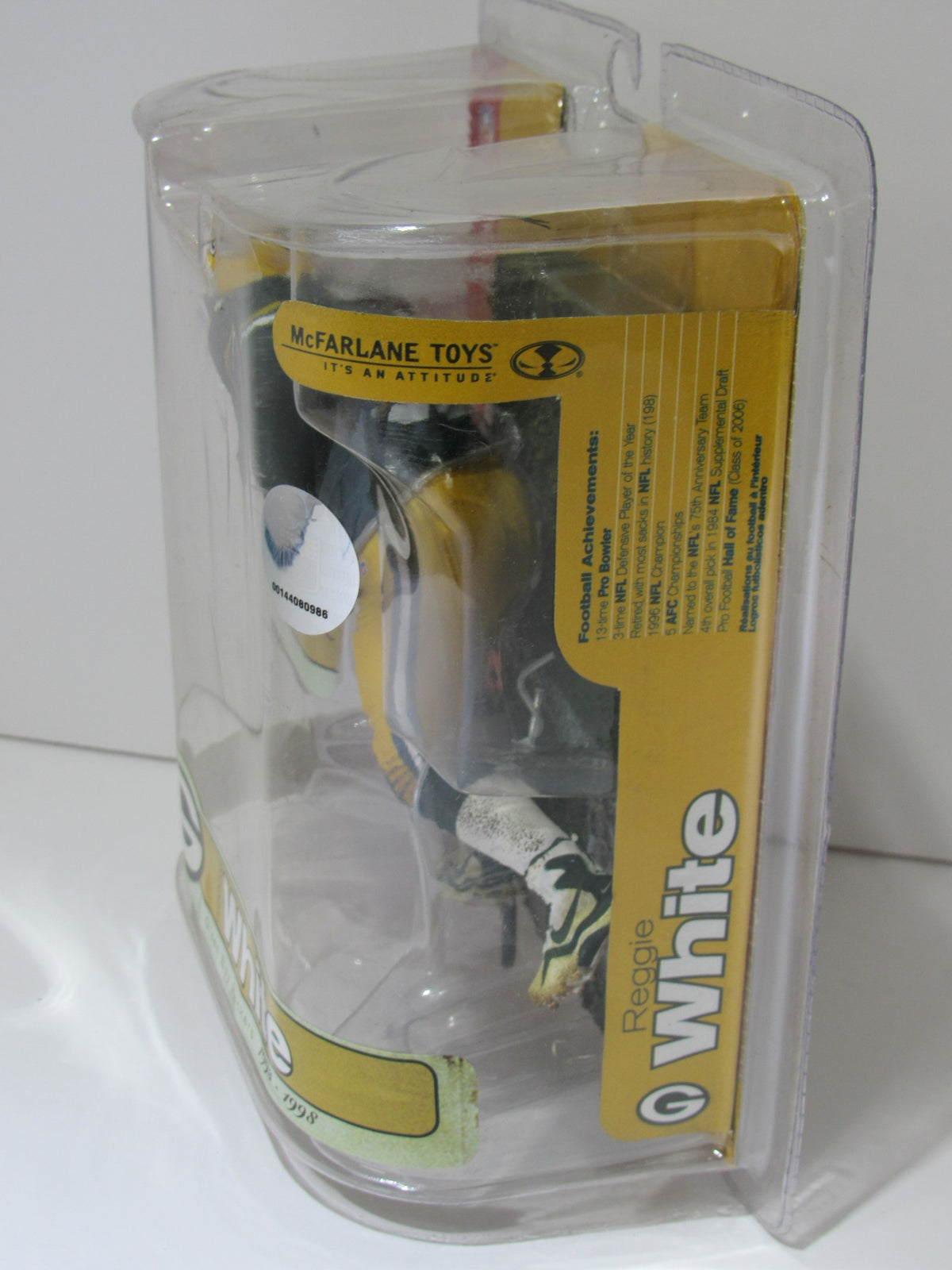 Side view of the McFarlane NFL Reggie White Green Bay Packers Action Figure packaging, displaying detailed features and branding.