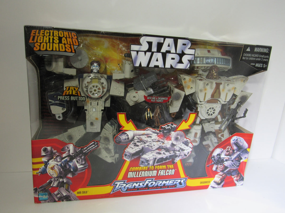 Star Wars Deluxe Transformer Han Solo and Chewbacca - Millennium Falcon packaged collectible featuring action figures and detailed design with electronic lights and sounds.