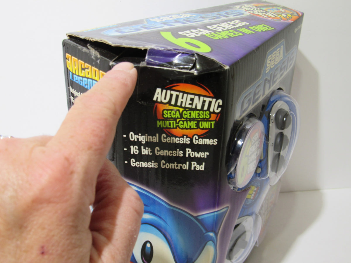 Close-up of the Sega Genesis Radica Plug and Play 6 Games-In-One box showing details including authenticity seal and mention of original Genesis games.