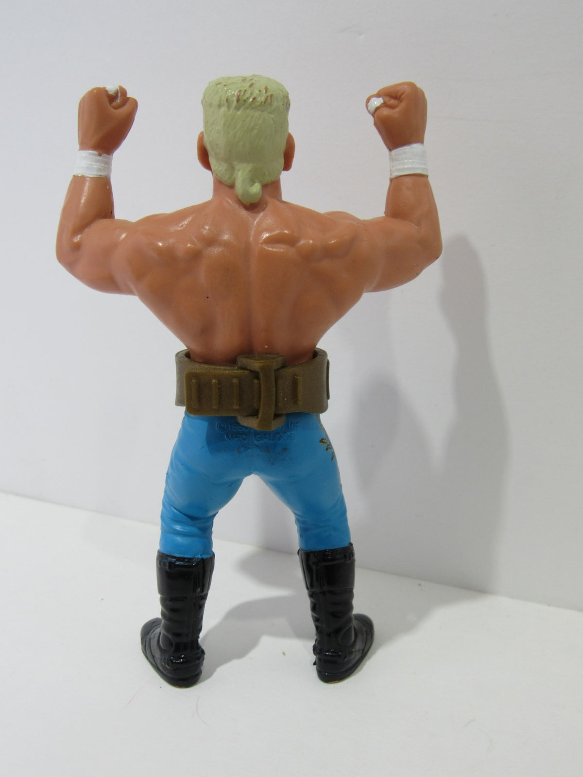 Rear view of the 1990 WCW Galoob Sting with Belt Action Figure displaying the action figure's muscular build.