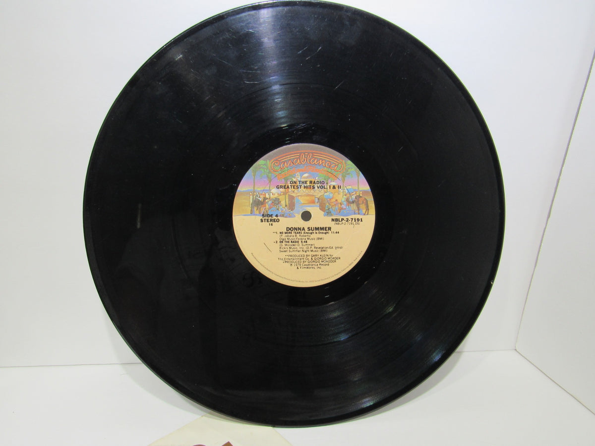 A flat view of 'Donna Summer: Greatest Hits on the Radio LP NBLP 27191' vinyl record highlighting grooves and label ID.