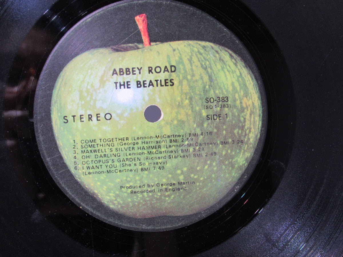 Detailed view of the tracklist on The Beatles: Abbey Road US Press Apple Records LP SO 383 vinyl, providing song details.