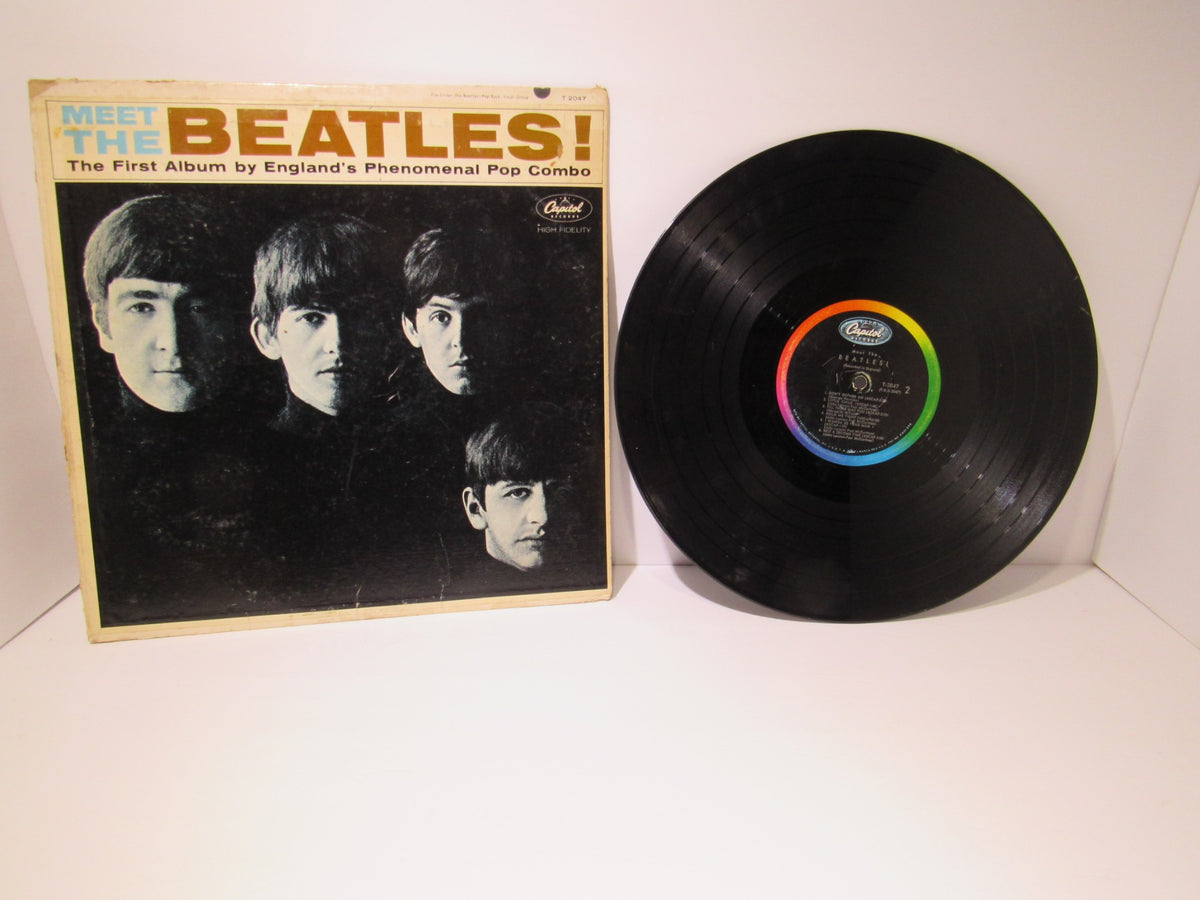The Beatles: Meet The Beatles US Mono Capitol Records LP T 2047 featuring the album cover photo with four band members, in a used condition with visible wear and tear.