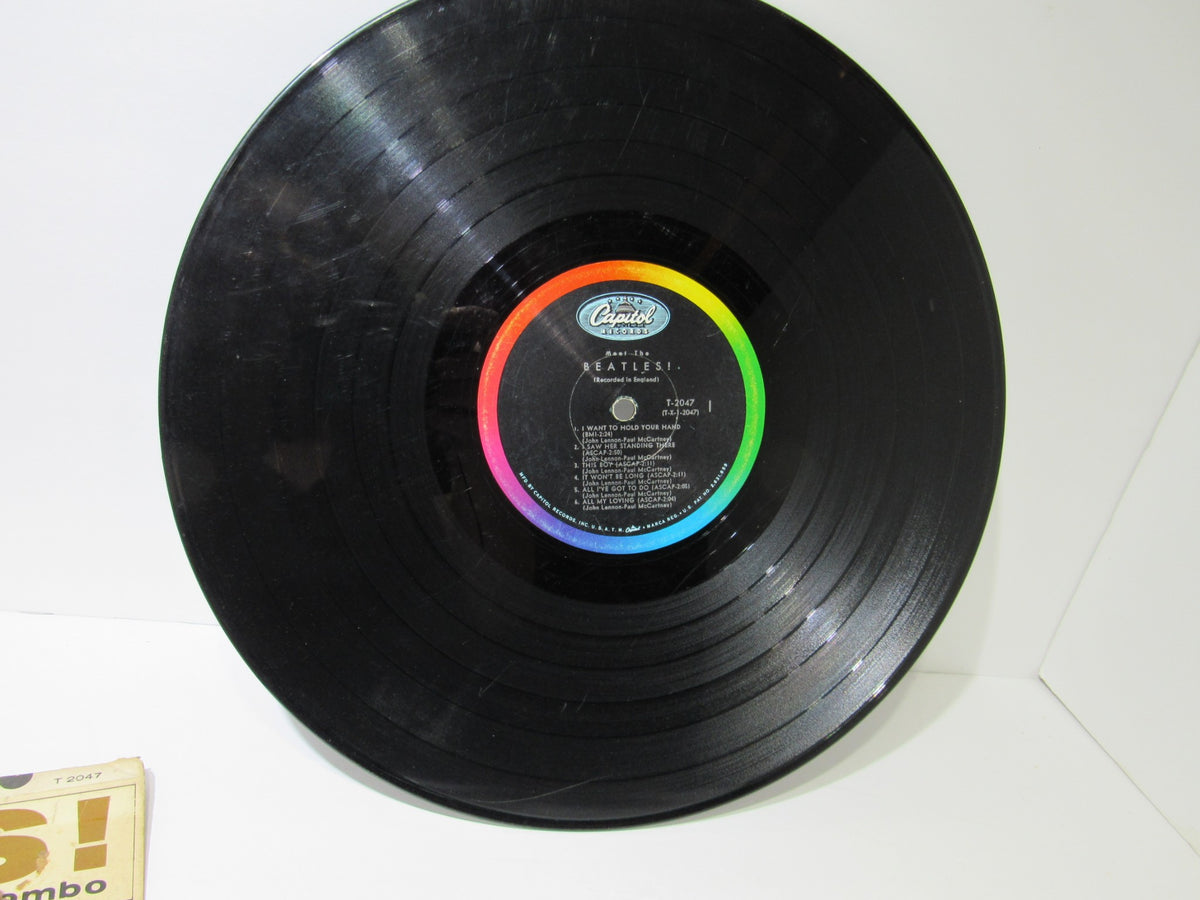 Top view of The Beatles: Meet The Beatles US Mono Capitol Records LP T 2047 with colorful label and black vinyl record.