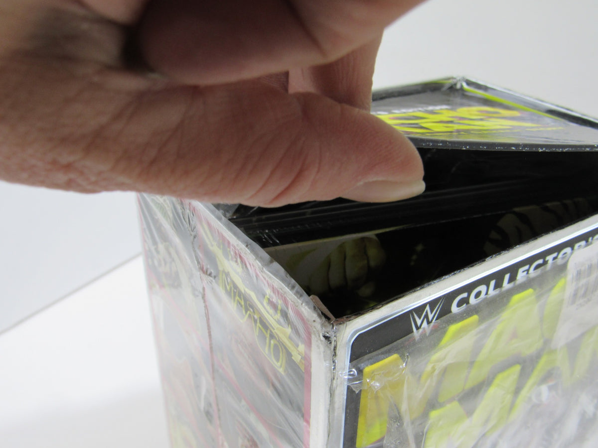 Hand opening the packaging of Macho Man: The Randy Savage Story Collector's Edition DVD, showcasing its kept condition.
