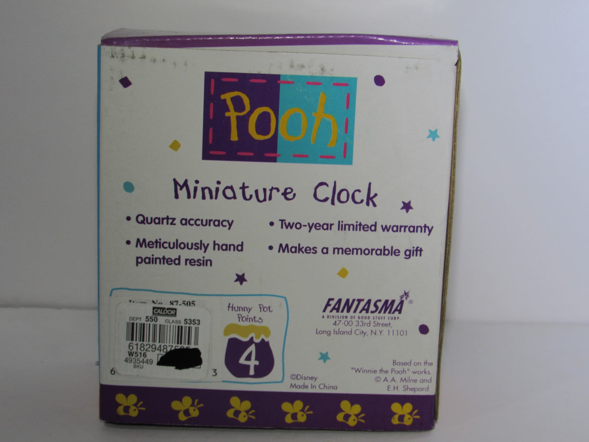 Back view of the Fantasma Walt Disney Winnie The Pooh Miniature Desk Office Clock box highlighting features like quartz accuracy and warranty details.