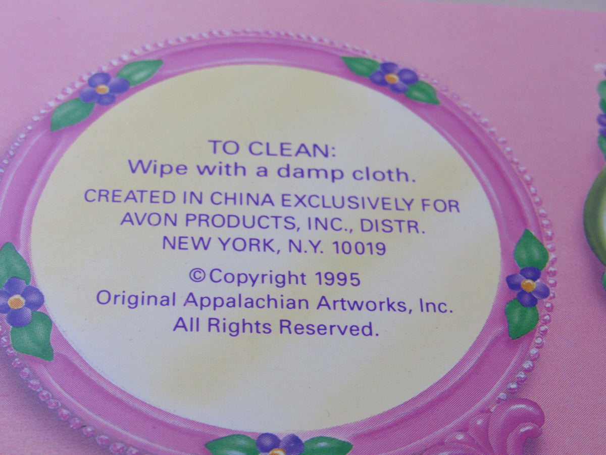 Close-up of the cleaning instructions and copyright information on the packaging of the 1995 Rare Avon Cabbage Patch Kids Portable Comb and Mirror Compact.