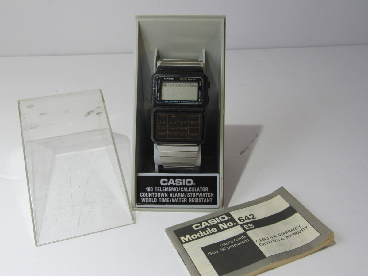 1985 Vintage Casio 563 DBC-60 Watch Data Bank Telememo Japan Made displayed in a clear case with manual.