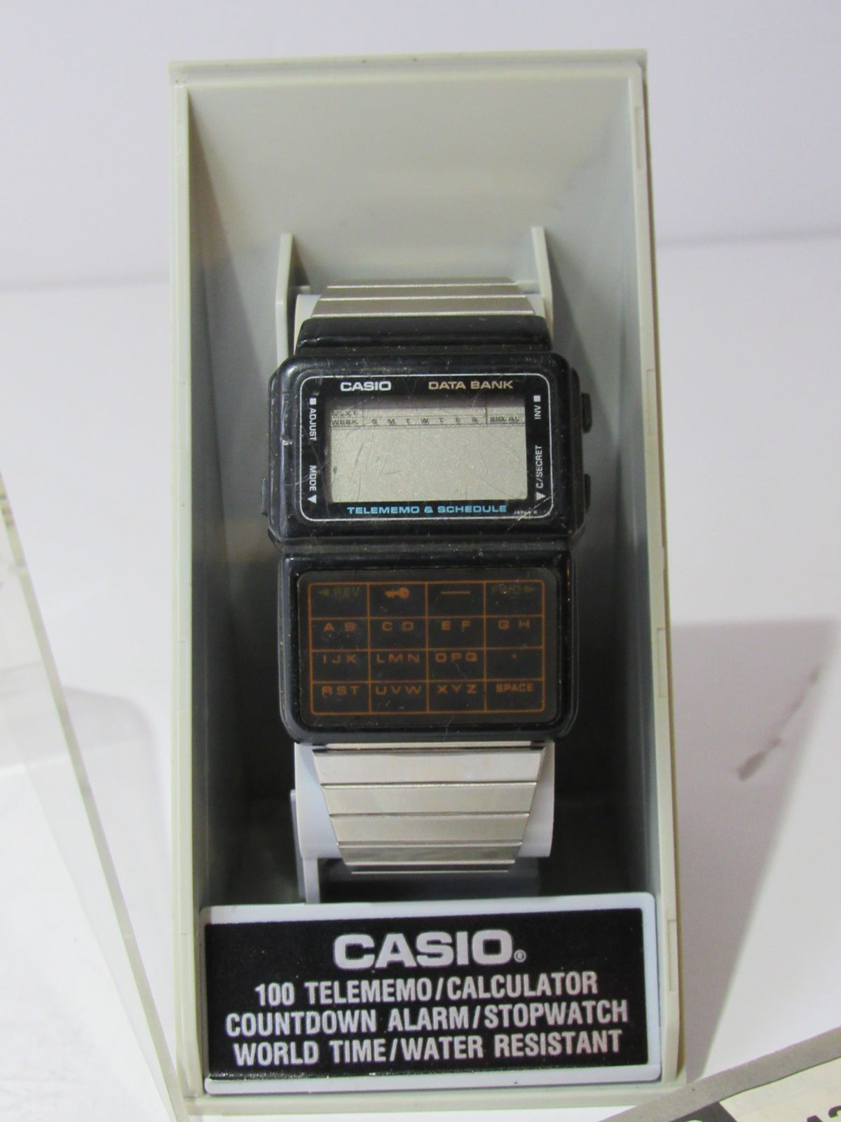 Close-up view of 1985 Vintage Casio 563 DBC-60 Watch Data Bank Telememo Japan Made showing digital display and buttons.