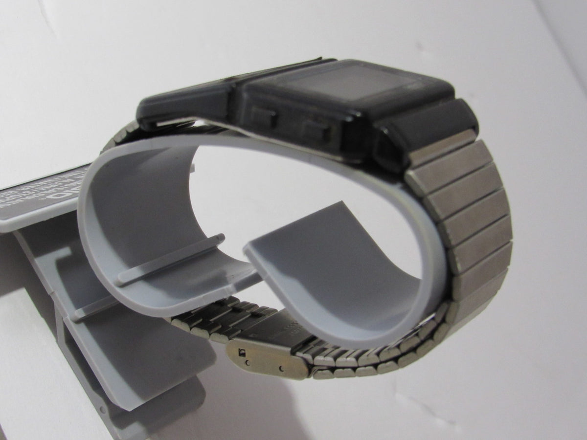 Side view of the 1985 Vintage Casio 563 DBC-60 Watch Data Bank Telememo showing its unique design and stainless steel strap.