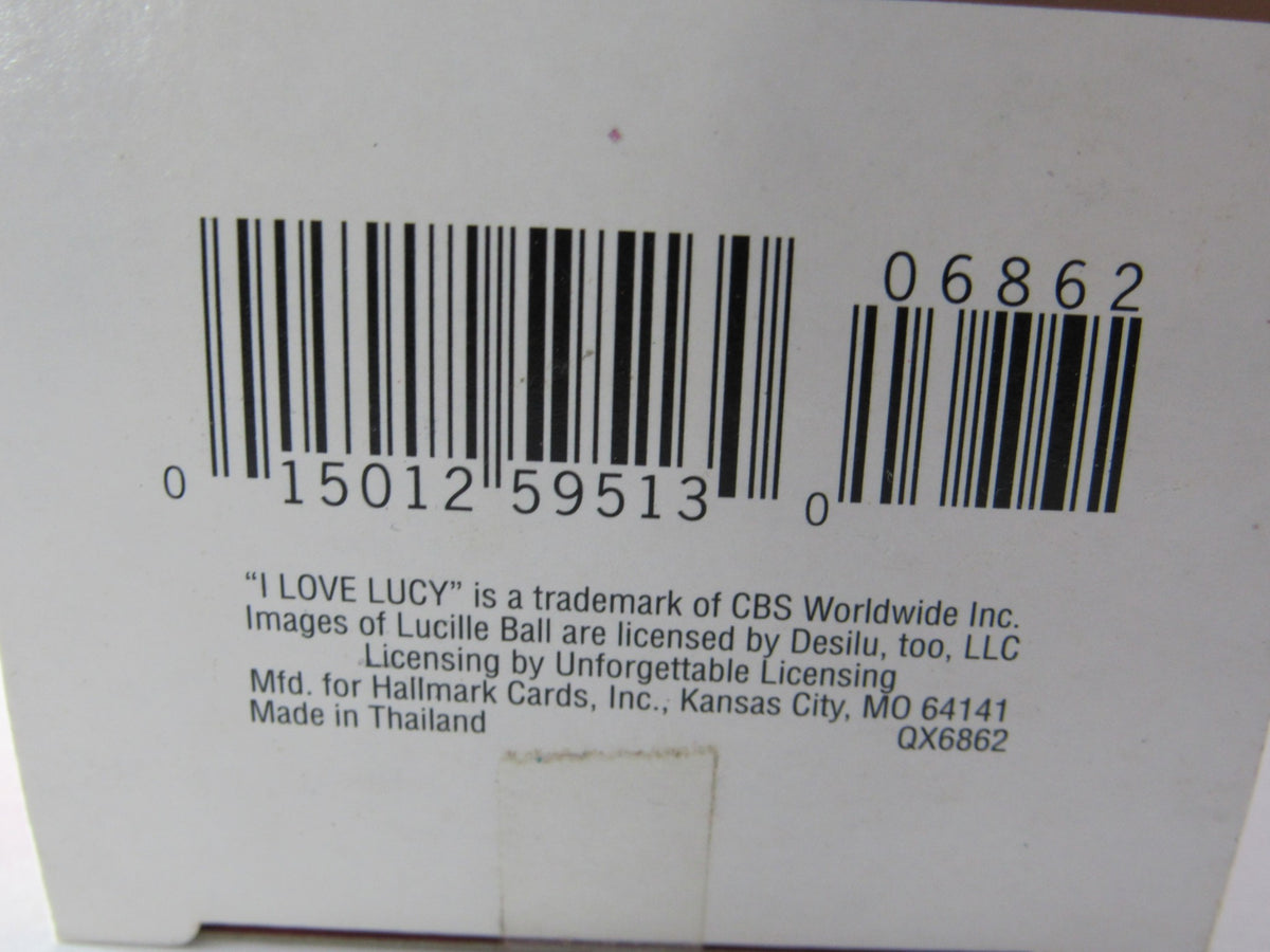 Close-up image of the bottom of the box for the 2001 Hallmark Keepsake Ornament I Love Lucy VitaMeataVegamin, including barcode and manufacturing details.