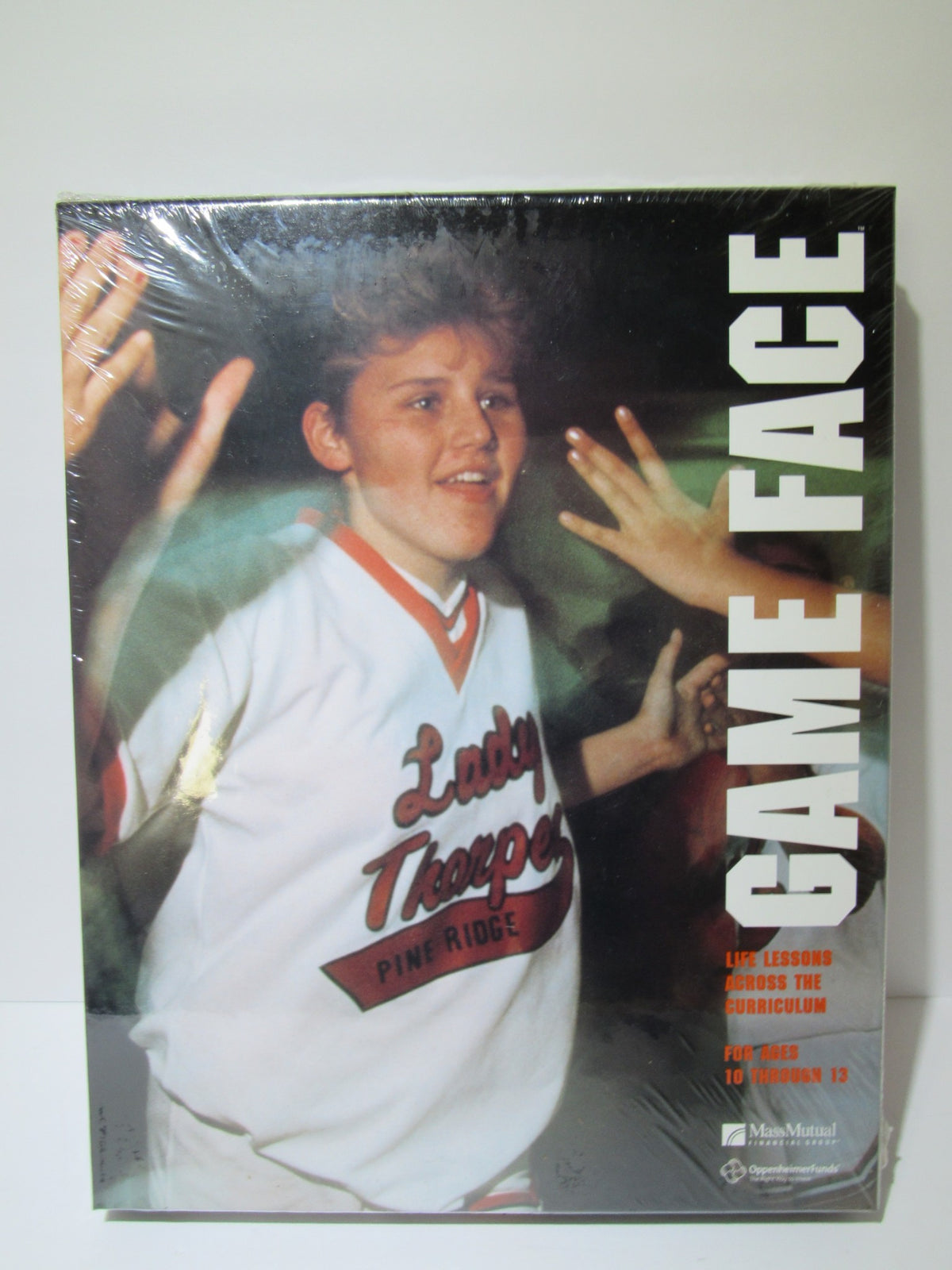 Front cover of 'Game Face: Life Lessons Across The Curriculum', featuring a young person engaged in interaction, showcasing themes of education and personal growth.