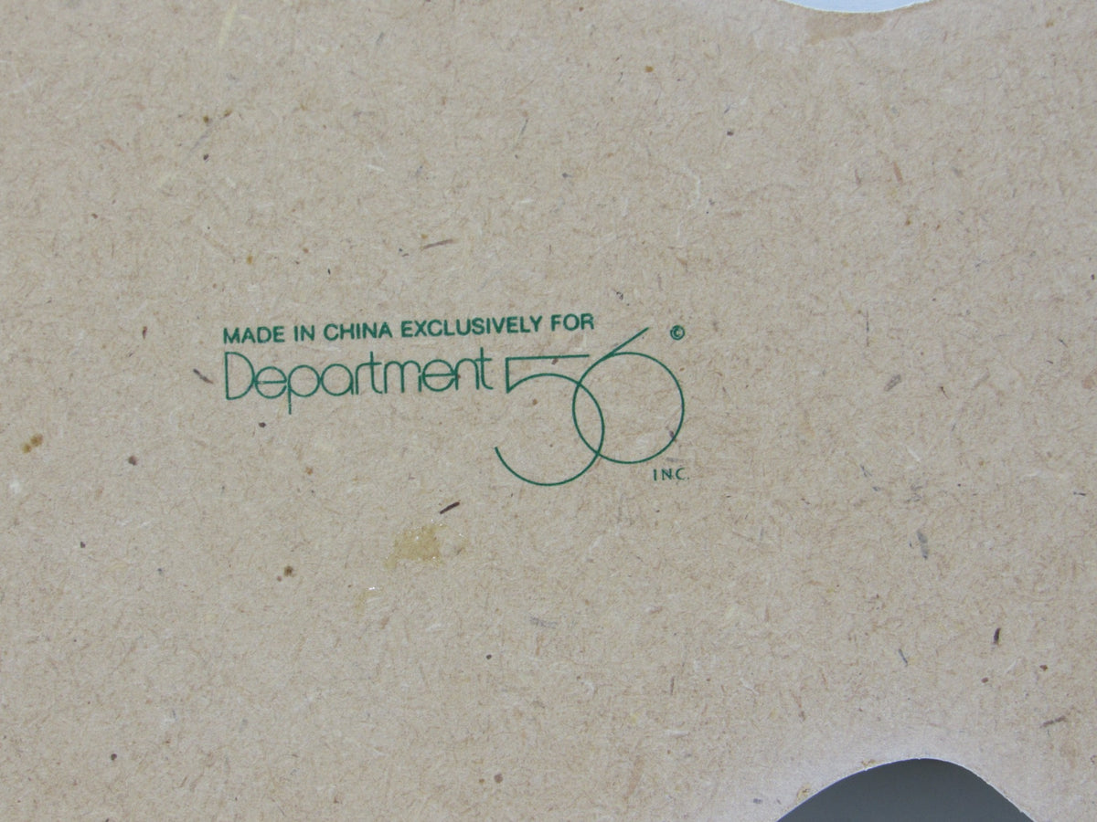 Close-up of the Department 56 logo on packaging, indicating the Vintage Department 56 Village Spruce Tree Forest with Wooden Base #5248-5 is made in China.