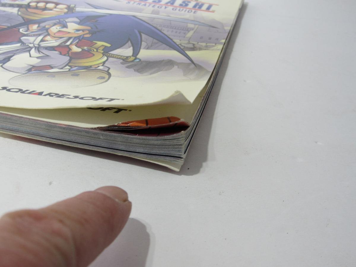 Side view of the Brady Games Squaresoft Official Brave Fencer Musashi Strategy Game Guide showing the quality and condition of the book's spine.