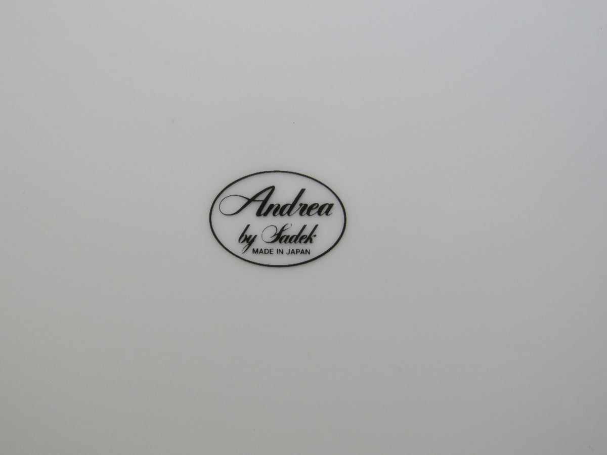 The bottom view of a porcelain piece showcasing the Andrea by Sadek mark, indicating it is part of the VTG Andrea by Sadek Porcelain Cake Plate & Server Floral Pattern Japan Made NEW.