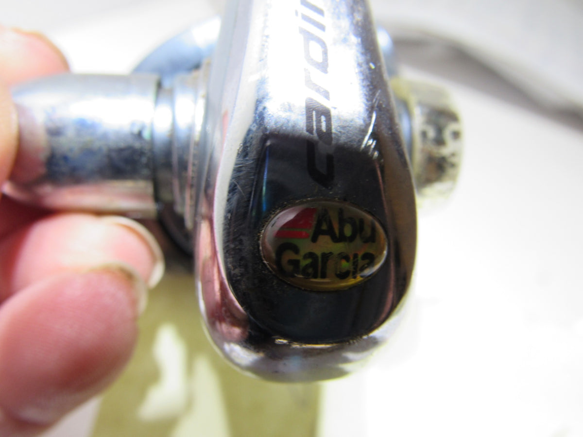 Close-up of the Abu Garcia logo on the Cardinal 6 Bearing Spinning Reel, showcasing its iconic design and craftsmanship, part of the vintage fishing gear collection with a gear ratio of 5.1:1.