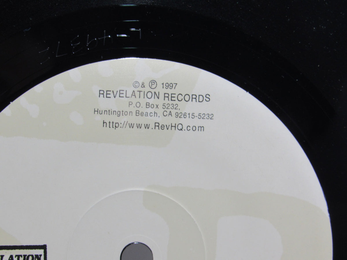 Close-up of the label on the vinyl record 'Kiss It Goodbye: Target Practice' showing details about Revelation Records and its address.