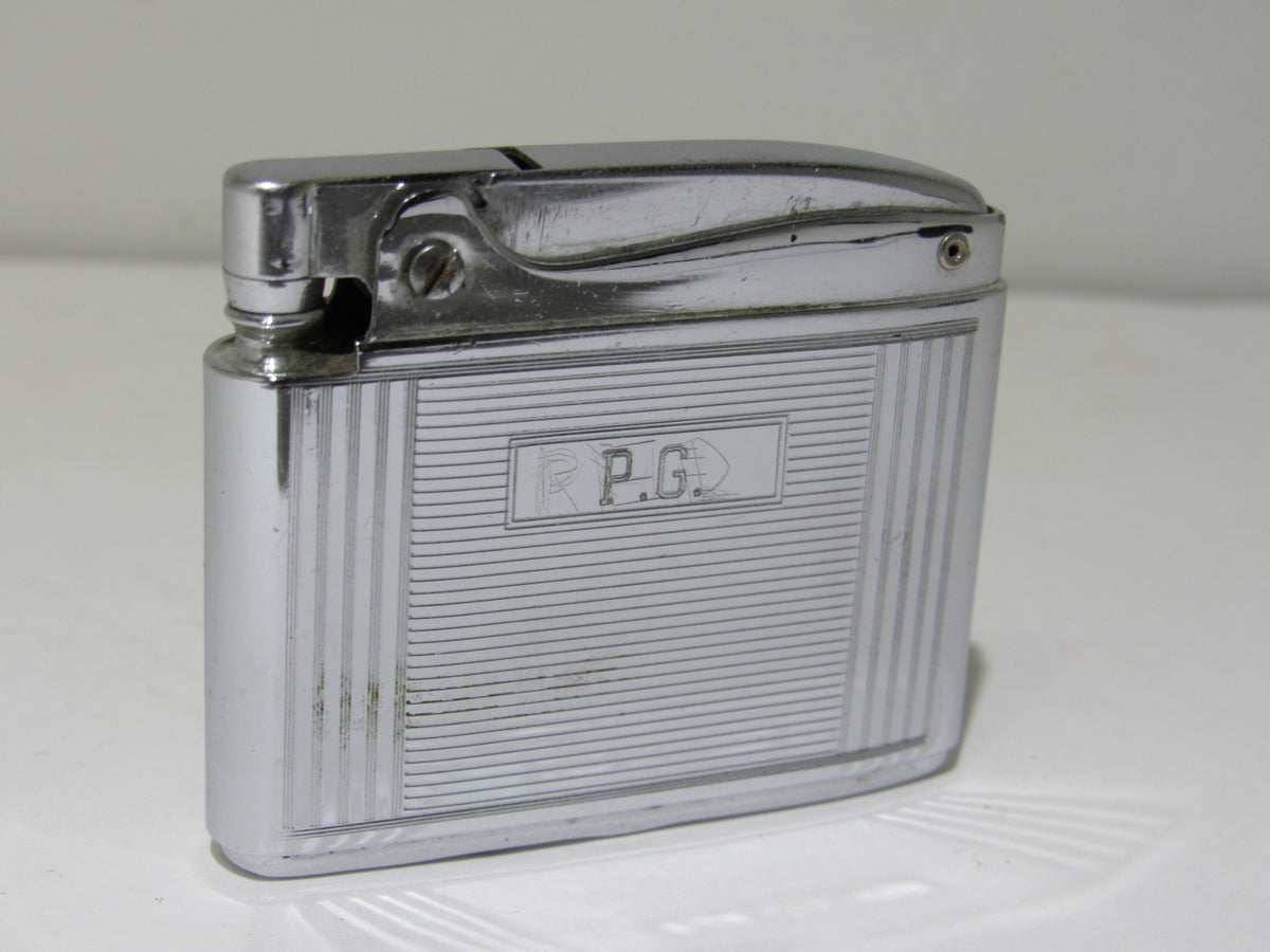 Vintage Ronson Adonis Chrome Striped Lighter #145217 featuring engraved initials P.G, showcasing a sleek chrome design and striped texture.