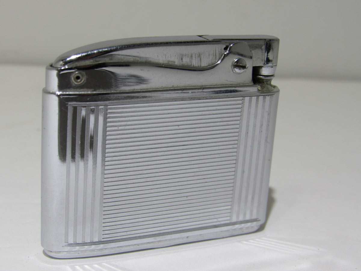 Vintage Ronson Adonis Chrome Striped Lighter #145217 showing a shiny chrome finish with horizontal stripes.