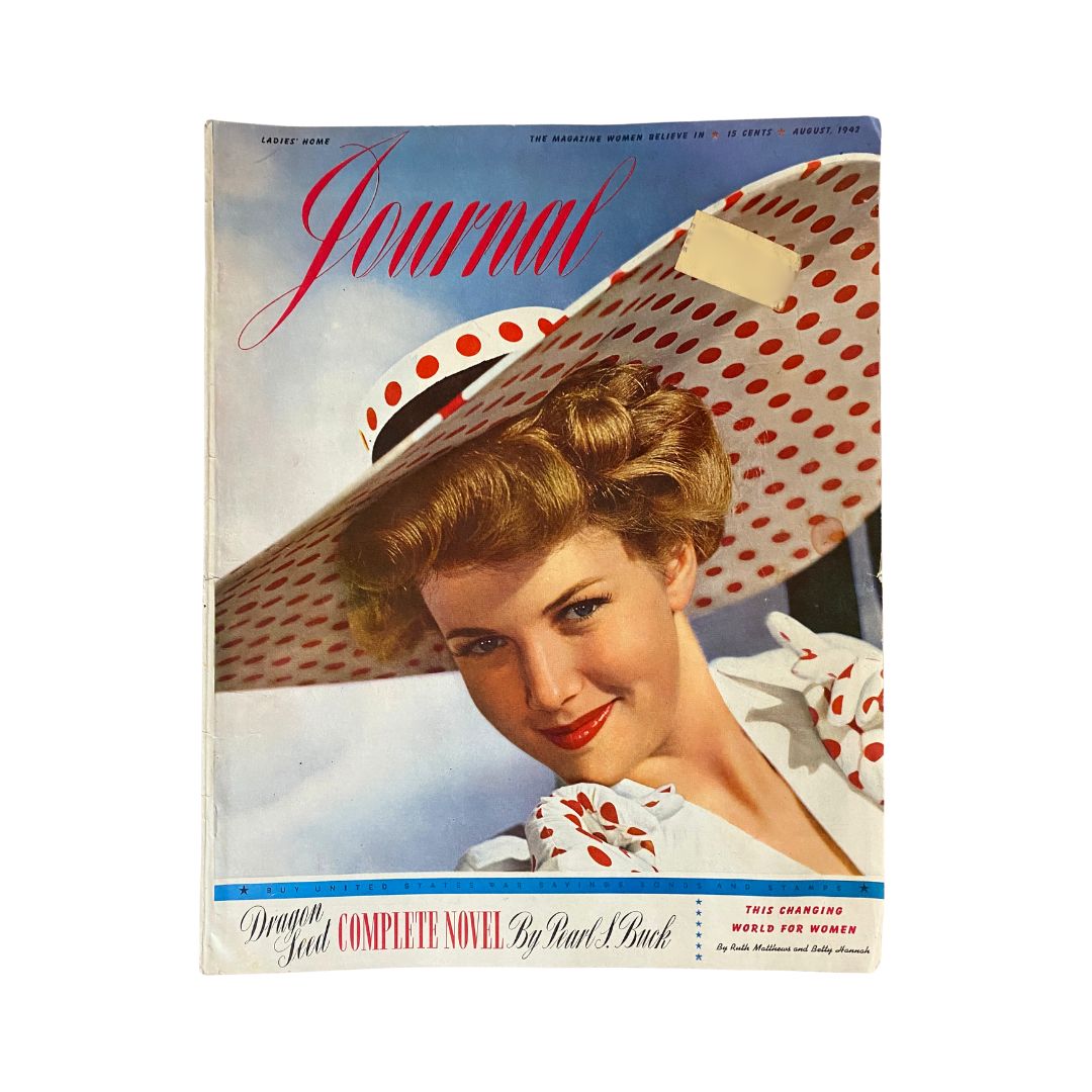Cover of the Ladies' Home Journal Magazine August 1942 titled 'This Changing World for Women', featuring a smiling woman in a large polka-dotted hat, symbolizing the fashion of the 1940s.