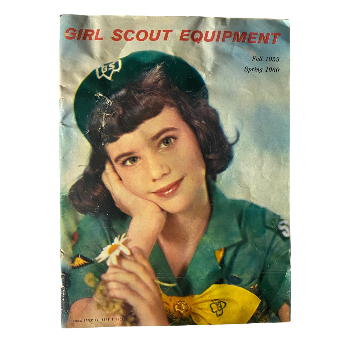 Cover of the Girl Scout Equipment Fall 1959 Spring 1960 Catalog featuring a young girl in a Girl Scout uniform holding a daisy, showcasing mid-century Girl Scouting culture.