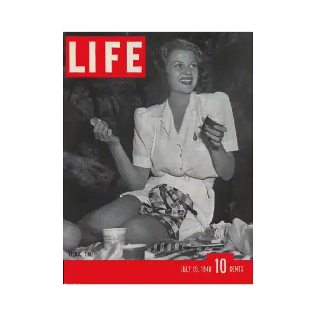 Cover of VTG Life Magazine from July 15, 1940 featuring Rita Hayworth, showcasing a picnic scene with a smiling young woman enjoying a treat, reflecting the vintage charm and glamour of classic Hollywood.