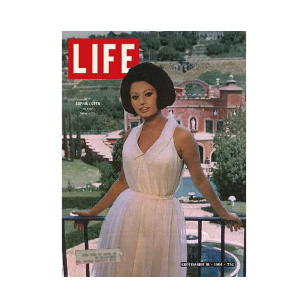 LIFE Magazine cover featuring Sophia Loren, September 18, 1964, showcasing the actress in a stylish white dress posed outdoors with a scenic backdrop.