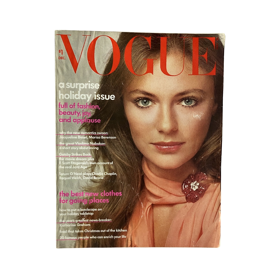 Vintage Vogue Magazine from December 1973 featuring Jacqueline Bisset on the cover, showcasing a stunning beauty look and holiday fashion themes.
