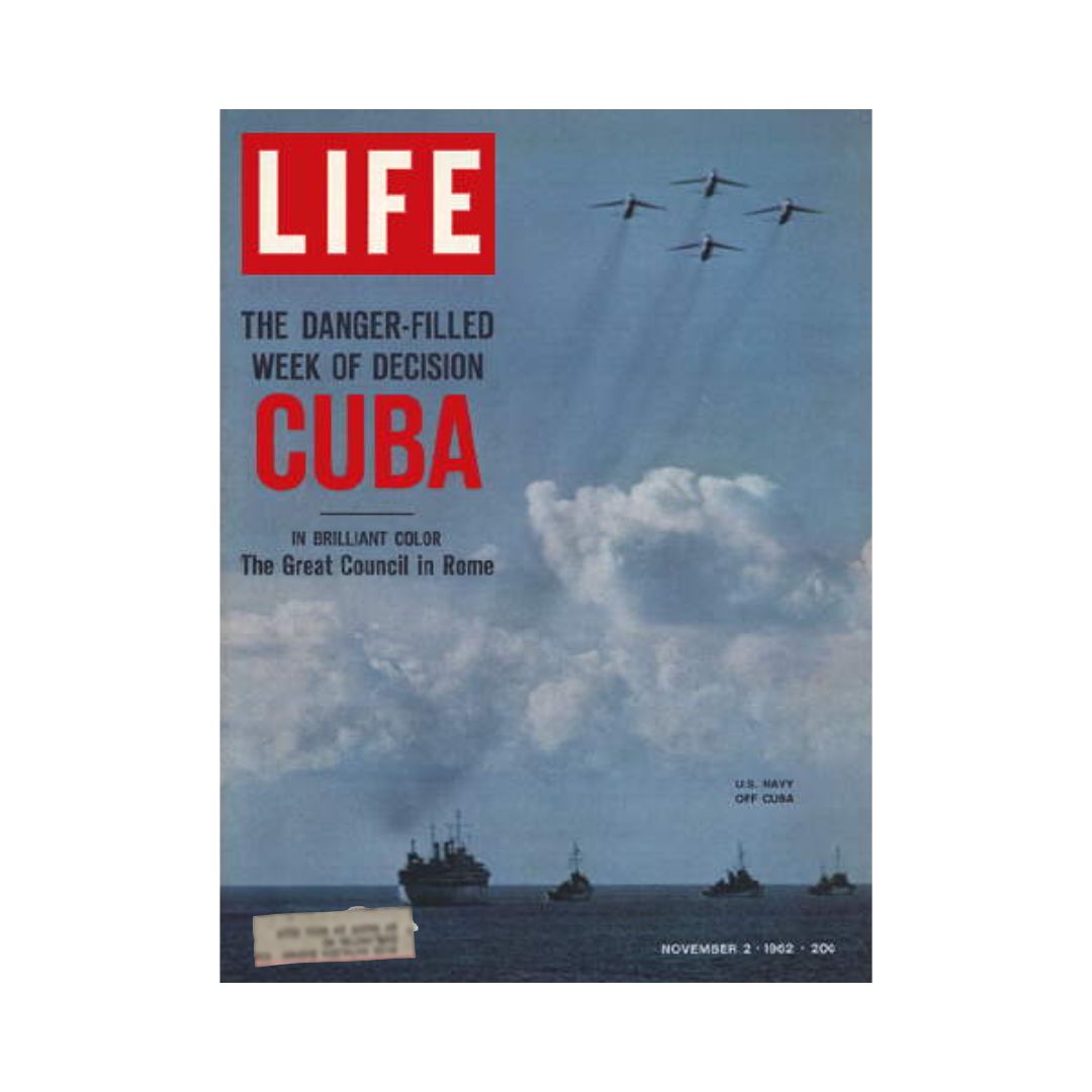 Cover of VTG Life Magazine from November 2, 1962, featuring the headline 'Cuba' and the subtitle 'The Danger-Filled Week of Decision'. The image includes a backdrop of clouds and naval vessels with planes flying above, highlighting the Cuban Missile Crisis.