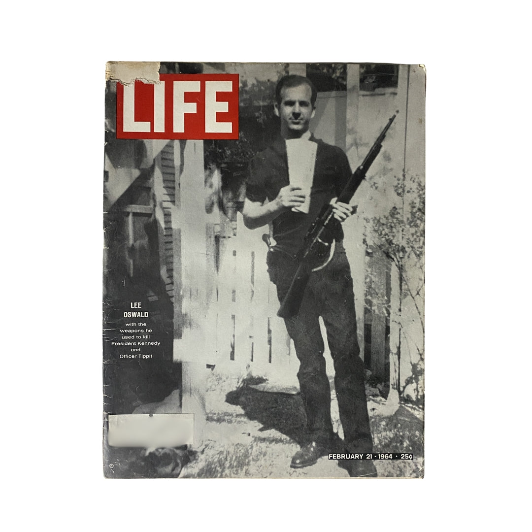 Vintage Life Magazine cover from February 21, 1964, featuring Lee Harvey Oswald holding a rifle linked to the assassination of JFK.
