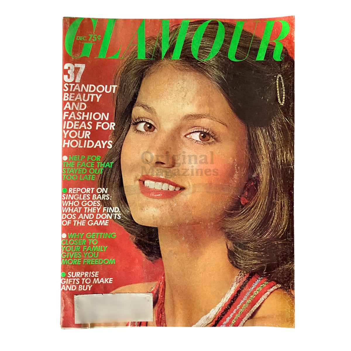 Cover of Glamour Magazine December 1973 featuring Barbara Minty, showcasing a classic beauty look typical of the 1970s era, adorned with the title prominently displayed in bold green.