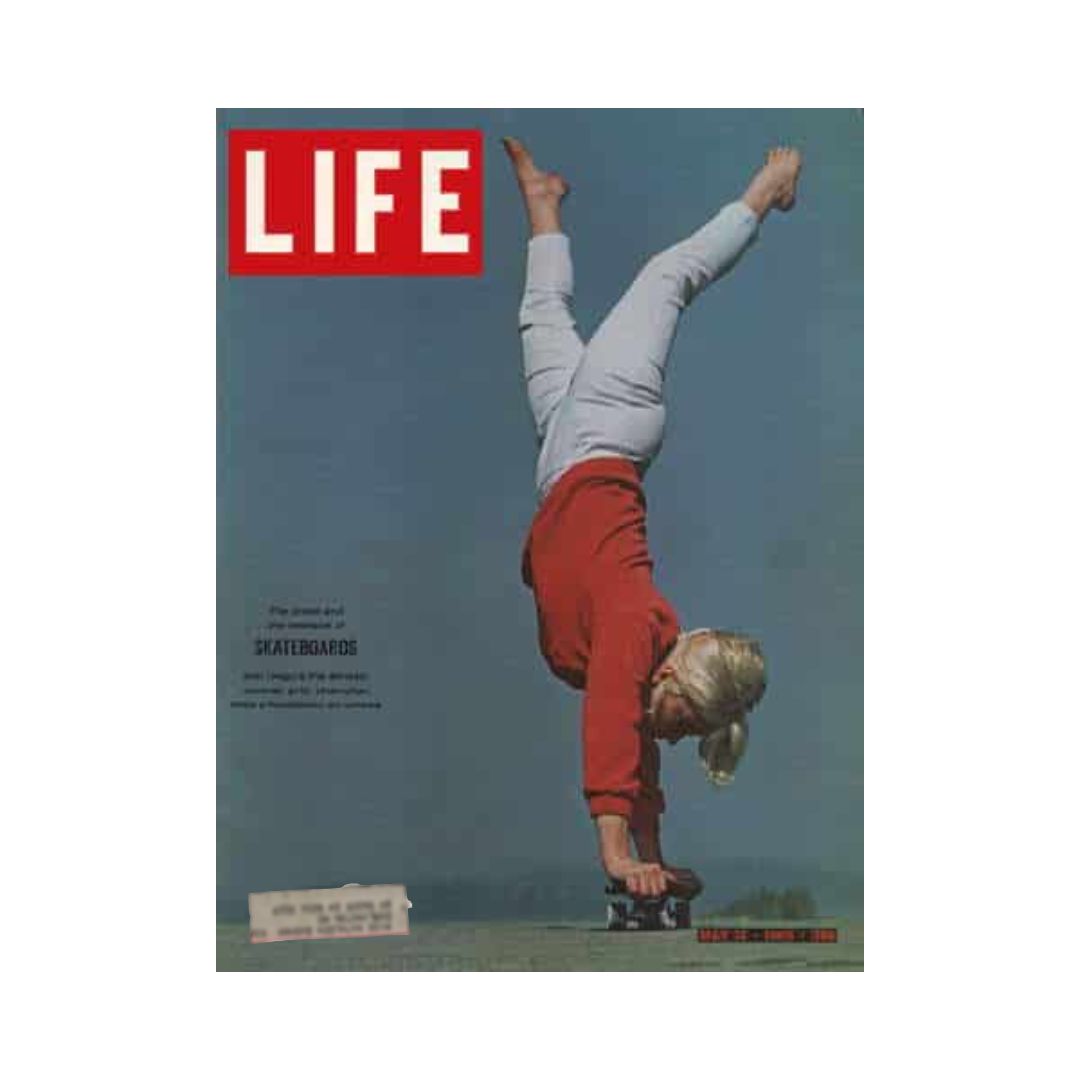 Cover of VTG Life Magazine May 14, 1965 featuring skateboarding. The image depicts a young girl in a red sweater performing a handstand on a skateboard against a clear sky, emphasizing the excitement of the 1960s skateboarding trend.
