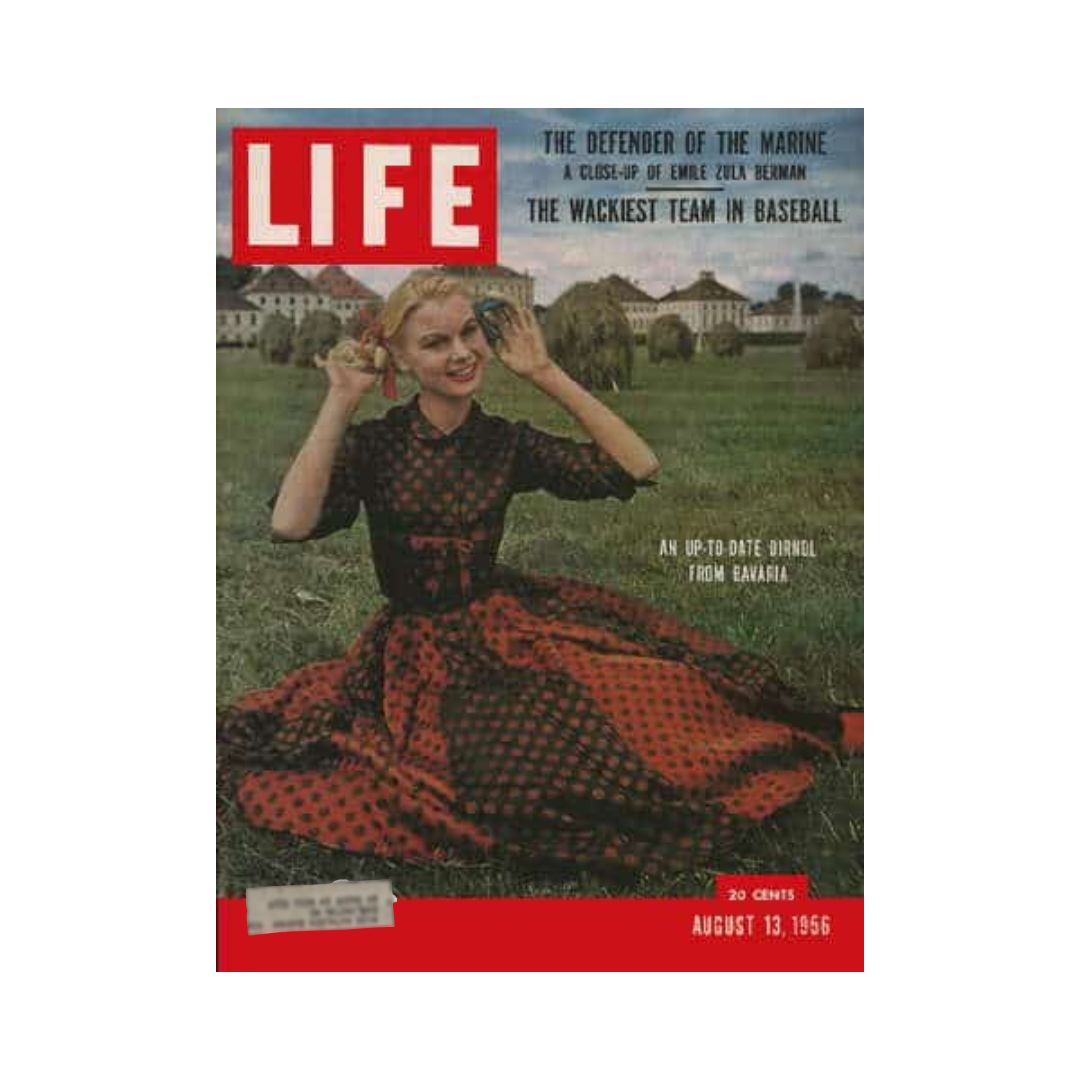 Cover of VTG Life Magazine from August 13, 1956, featuring a model in a red and black polka dot dress, showcasing Bavarian fashion. The magazine highlights cultural events and fashion trends of the 1950s.