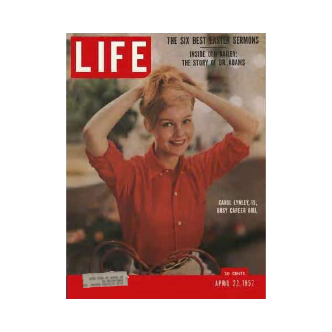 Cover of VTG Life Magazine April 22, 1957 featuring Carol Lynley at age 15, showcasing her in a red blouse with her hands in her hair, described as 'busy career girl'. The magazine focuses on notable stories from that time.