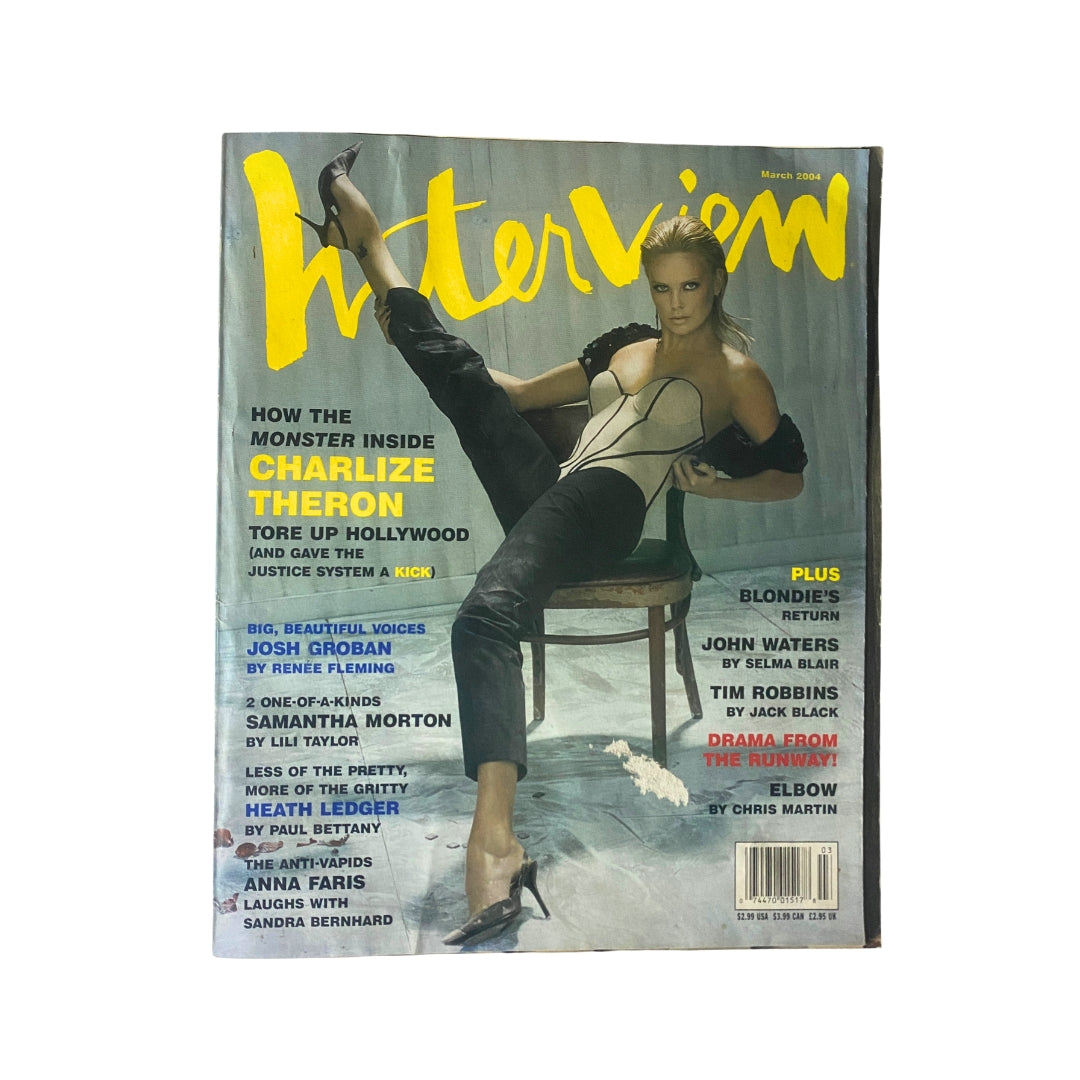 Interview Magazine March 2004 featuring Charlize Theron on the cover, showcasing a glamorous photo of the actress in a striking outfit. This collectible vintage magazine captures early 2000s pop culture.