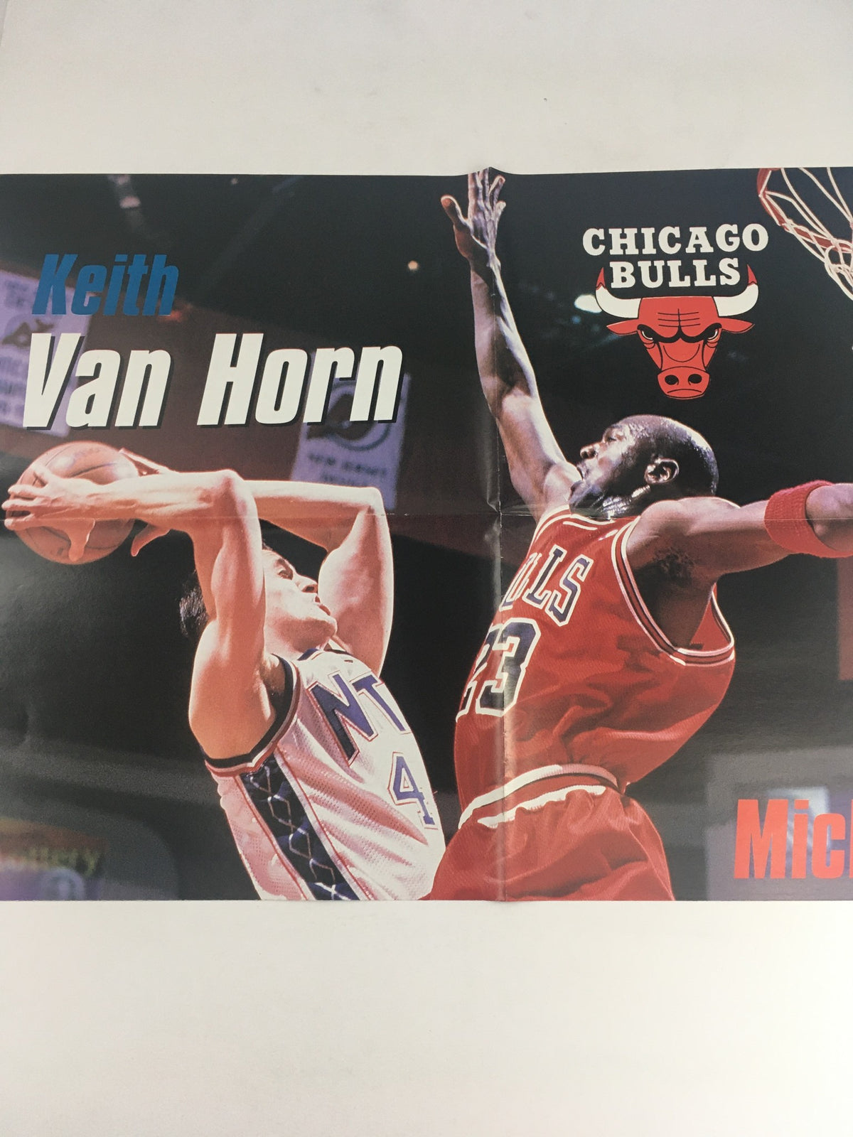 Poster within XXL Basketball Magazine April 1998 featuring Keith Van Horn and Michael Jordan in action, showcasing their rivalry on the basketball court.