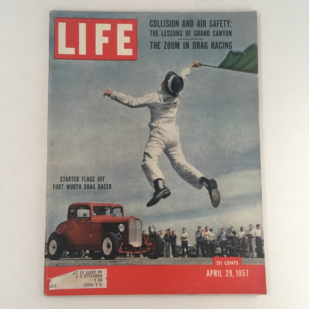 Life Magazine cover from April 29, 1957, featuring the starter flagging off a Fort Worth drag racer. Vintage photography showcasing early drag racing culture with a prominent red car and onlookers.