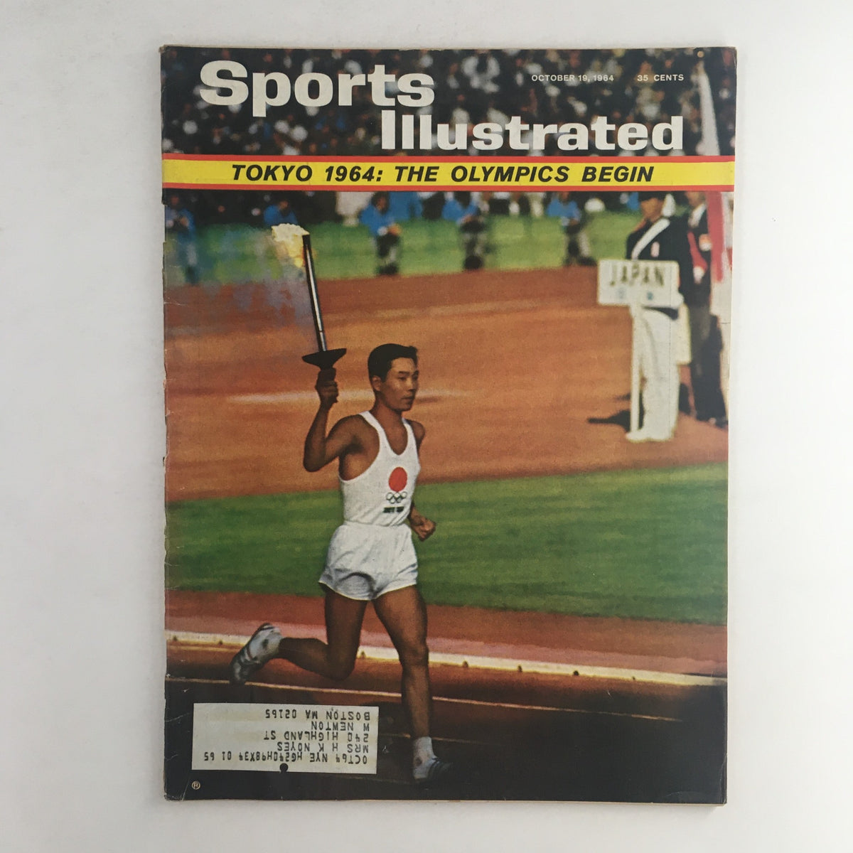 Cover of Sports Illustrated Magazine, October 19, 1964, featuring the Tokyo 1964 Olympics with an athlete holding a torch. The magazine highlights 'The Olympics Begin' symbolizing the significance of the first Olympics held in Asia.