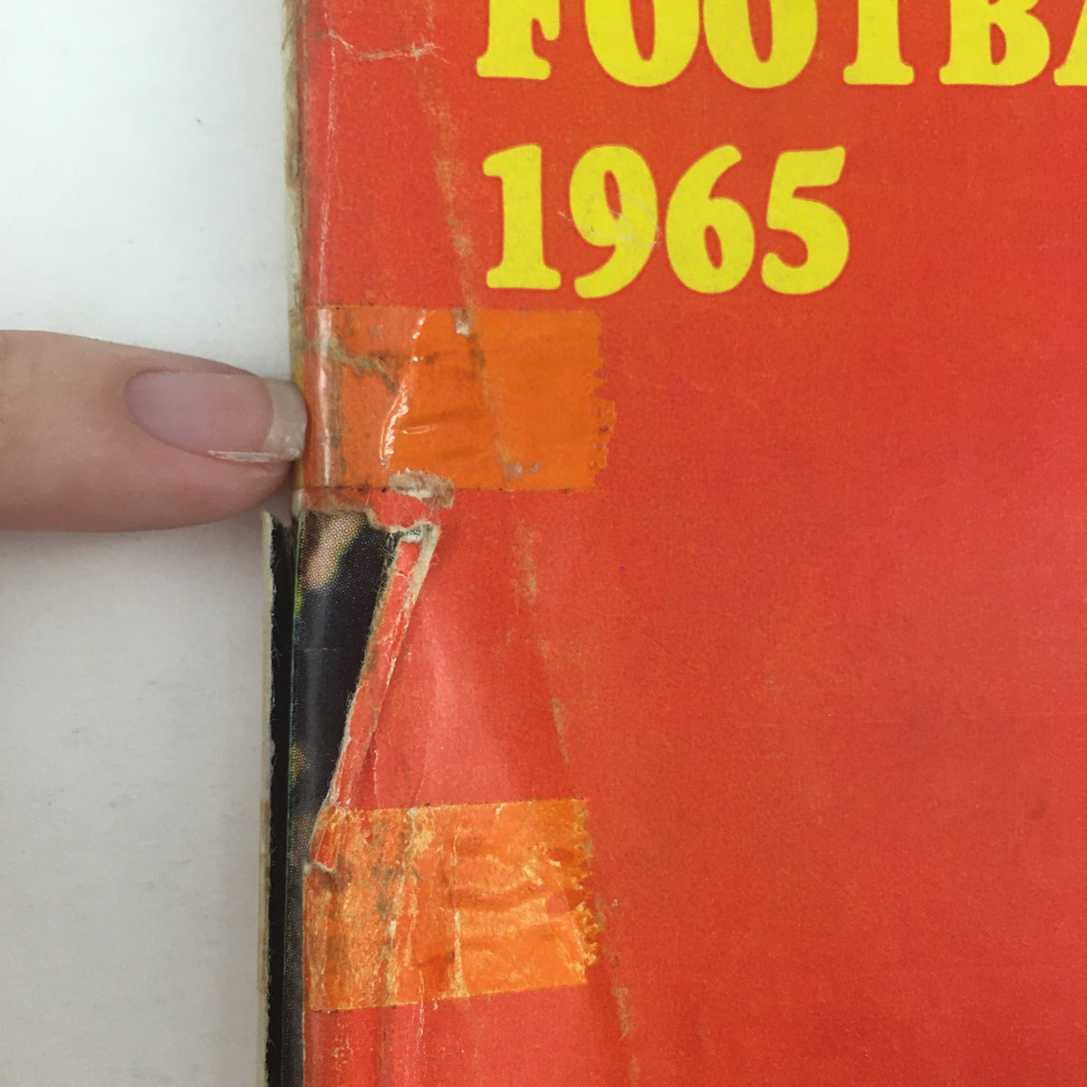 Detailed look at the spine of the Sports Illustrated Magazine from September 13, 1965, showing wear and tape repairs, emphasizing its vintage quality.