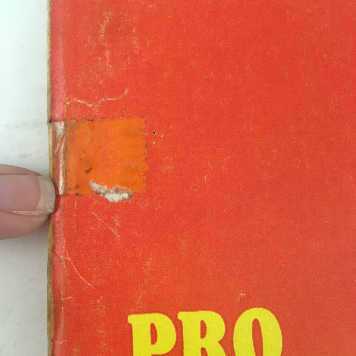 Close-up view of the spine of the Sports Illustrated Magazine from September 13, 1965, highlighting wear and an address label, showcasing the vintage condition of a collectible featuring Fran Tarkenton leading the Vikings.
