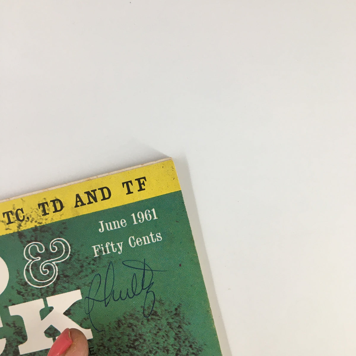 Close-up of the vintage Road & Track Magazine from June 1961, highlighting its title and date, along with a signature, perfect for collectors of automotive memorabilia.