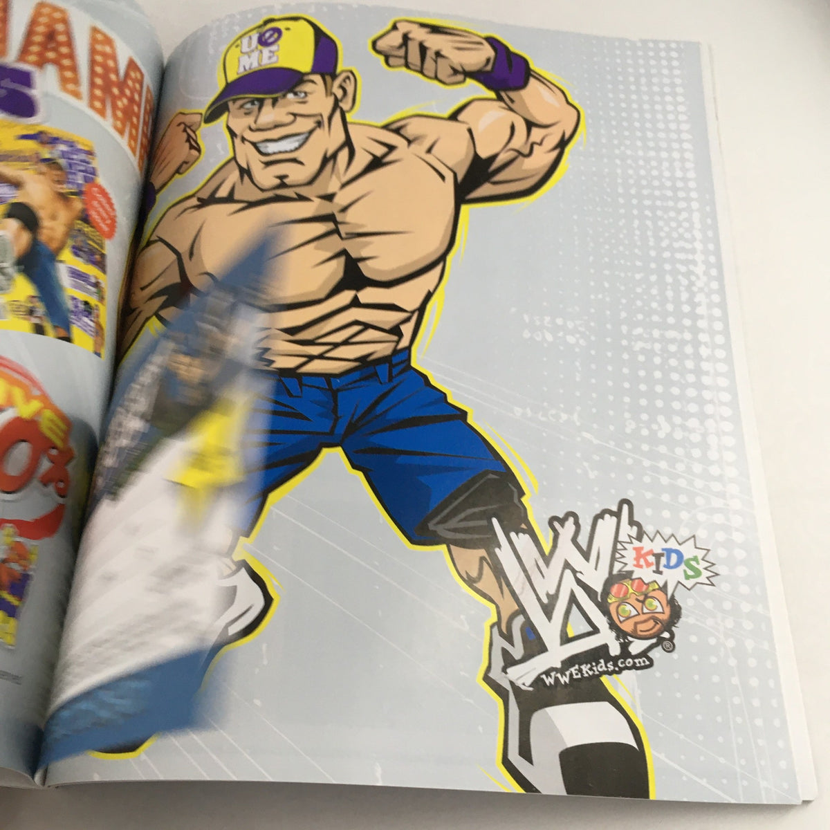 WWF Magazine 2011 Wrestle Mania XXVII highlighting John Cena character in a colorful, dynamic illustration.