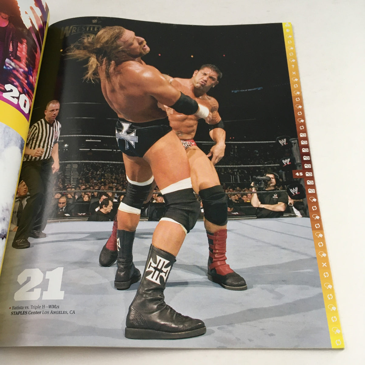 WWF Magazine 2010 Wrestle Mania XXVI Almanac capturing an intense moment between Triple H and another competitor in the ring.