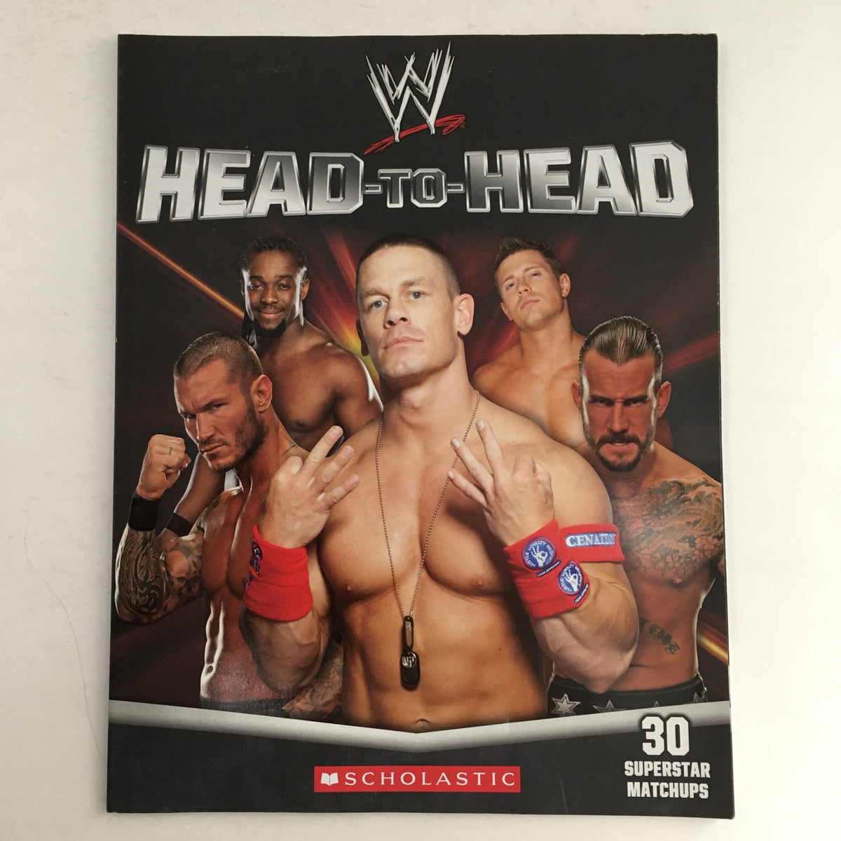 Cover of WWE WWF Magazine 2012 Head-to-Head featuring John Cena and CM Punk, along with other wrestlers, highlighting 30 Superstar matchups.