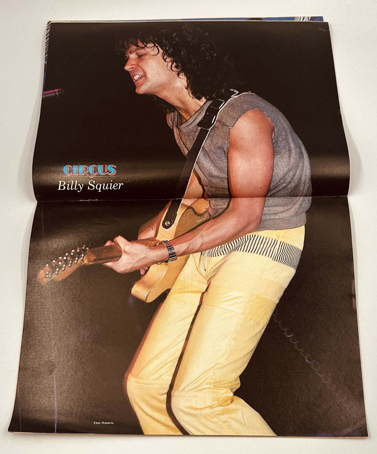 Poster of Billy Squier in Circus Magazine May 31, 1983, showcasing the musician performing energetically on stage.